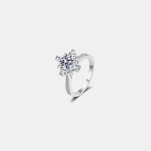 Sterling silver ring with a round-cut diamond in a floral setting and pave band.