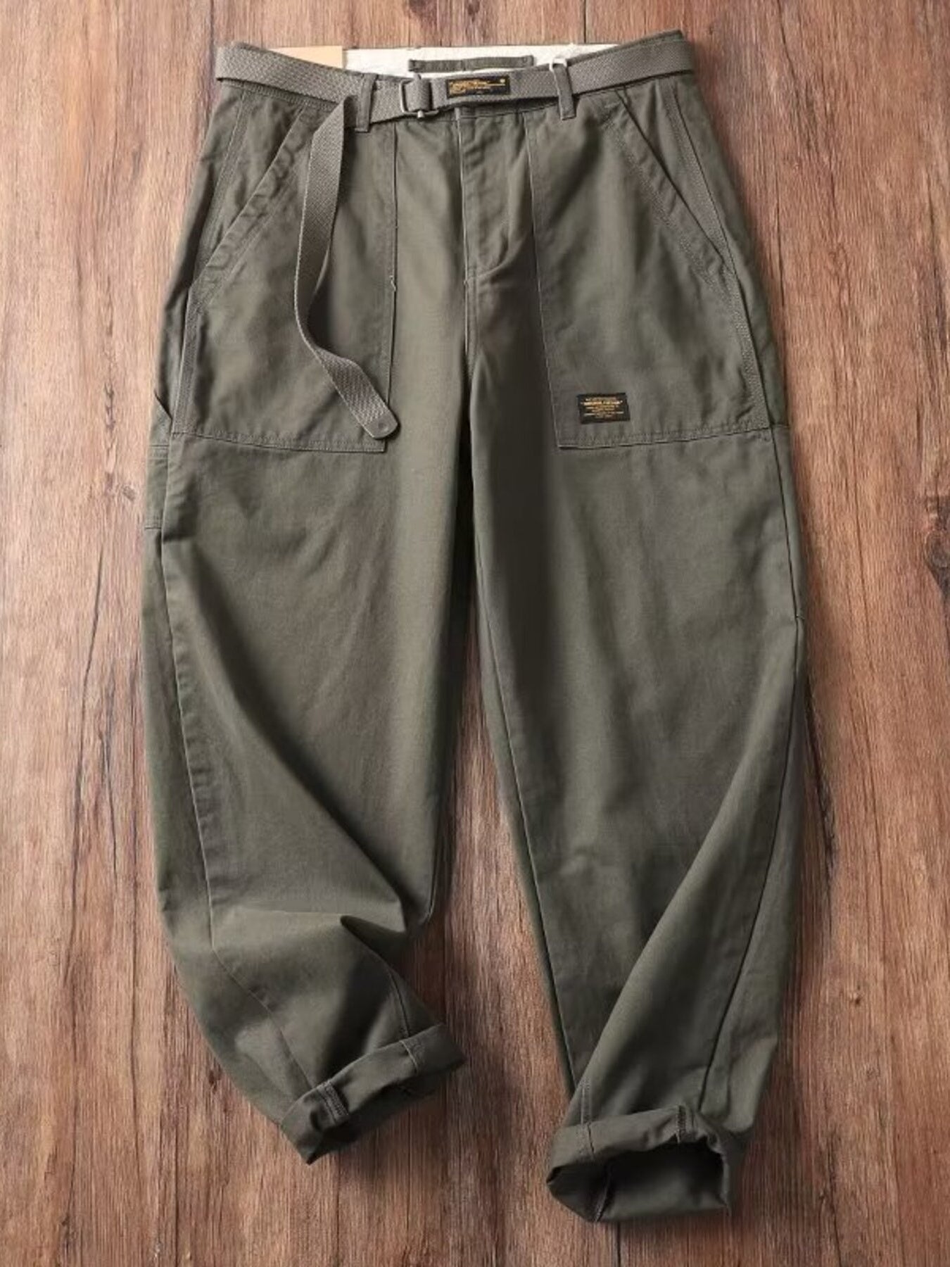 Men's olive green loose fit cargo pants with pockets and belt