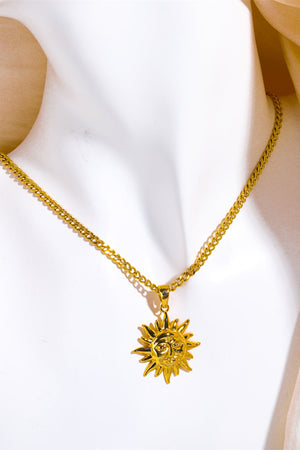 Golden sunburst pendant necklace with curb chain