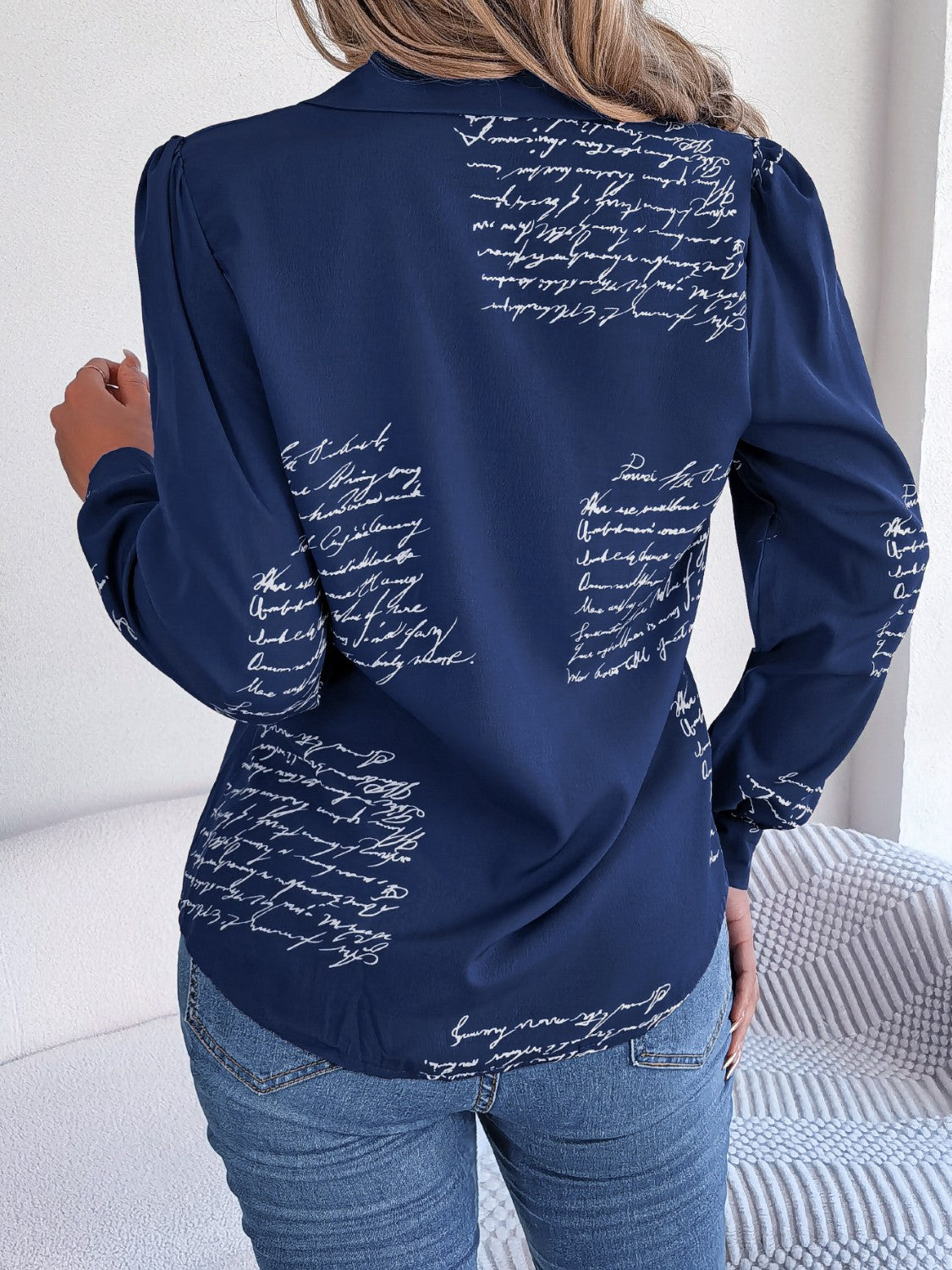 Dark blue collared blouse with white script pattern and puff sleeves