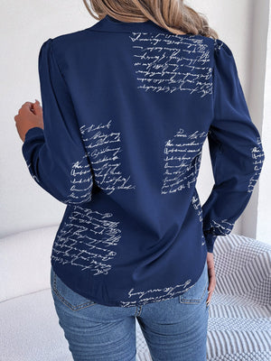 Dark blue collared blouse with white script pattern and puff sleeves
