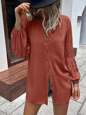 Oversized rust blouse with mandarin collar, button front, and balloon sleeves.
