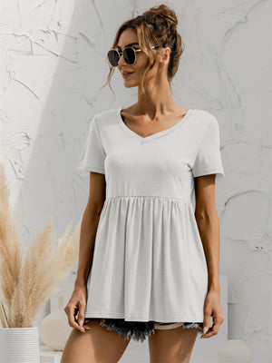White v-neck tee with gathered waistline and short sleeves