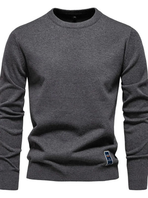 Gray crew neck knit sweater with ribbed cuffs and hem, featuring a small logo patch.