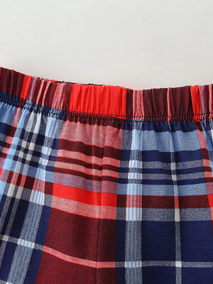 Baby boys' plaid shorts with elastic waistband in red, blue, and white.