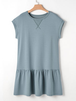 French blue cotton cap sleeve drop waist t-shirt dress with ruffled hem and contrast stitching detail.