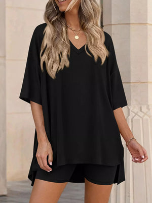 Black V-neck two-piece set with oversized short-sleeve top and ribbed shorts.