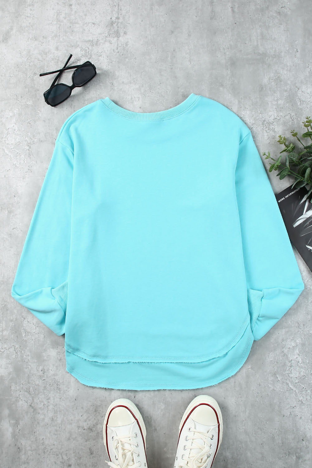 Aqua sweatshirt with asymmetric hemline and raw edge detail