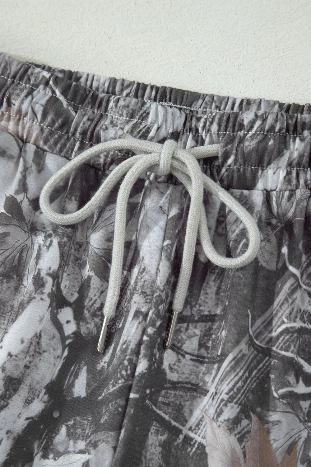 Maple leaf print elastic waist shorts with drawstring detail