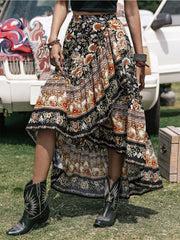 Bohemian floral asymmetric midi skirt with tiered ruffles and a ruffled hem.