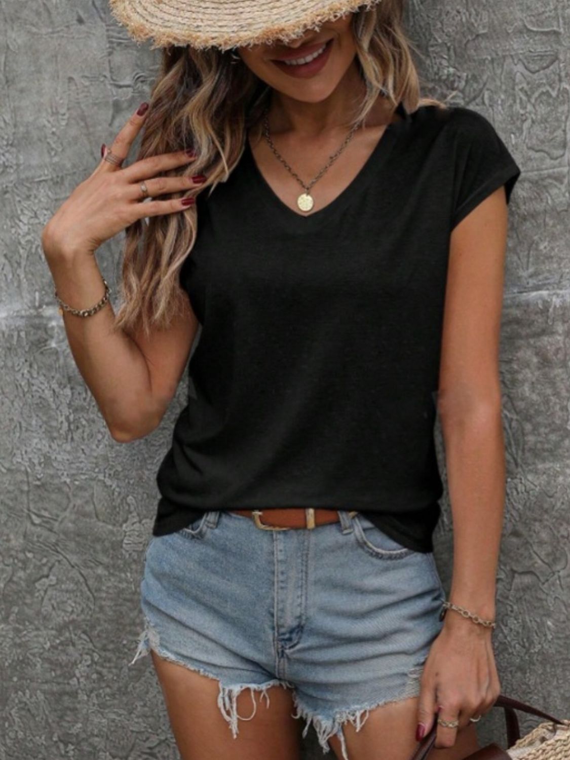 Black cap sleeve slouchy v-neck tee with a relaxed fit.