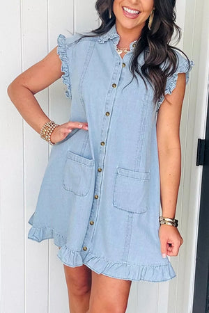 Light wash denim shift dress with ruffled collar, sleeves, and hem, button front, and chest pockets.