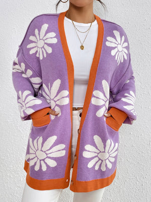 Floral jacquard knit cardigan in lavender with white flowers, orange trim, and button front.