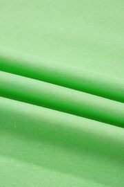 Green cotton two-piece set with pants, showing fabric texture and folds.