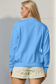 Sky blue crewneck sweater, 100% polyester knit, with long sleeves and ribbed cuffs and hem.