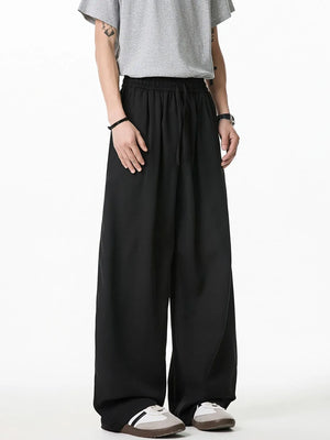 Black relaxed palazzo trousers with drawstring waist and wide leg
