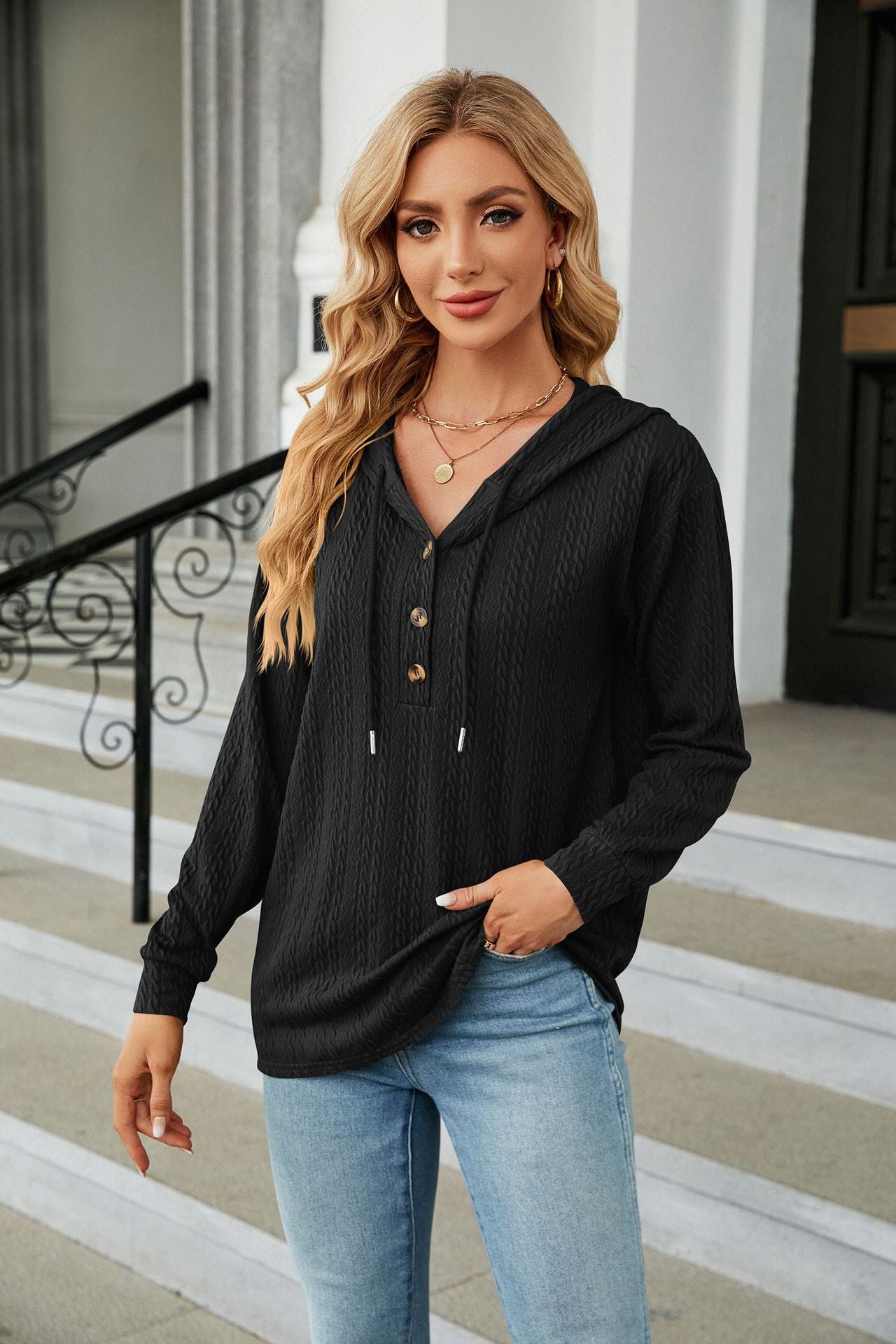Black textured henley hooded knit top with button detail and drawstring hood