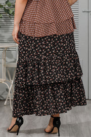 Black tiered floral maxi skirt with ruffled tiers and a boho casual style.