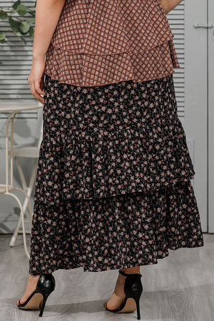 Black tiered floral maxi skirt with ruffled tiers and a boho casual style.