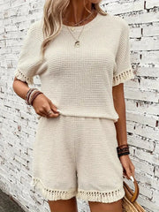 Cream textured knit outfit set with fringe detail on short sleeves and hem.
