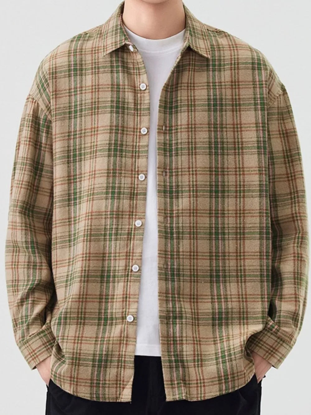 Relaxed fit cotton plaid button-up shirt in green grid pattern.