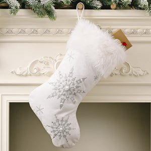 White Christmas stocking with silver embroidered snowflakes and faux fur trim.