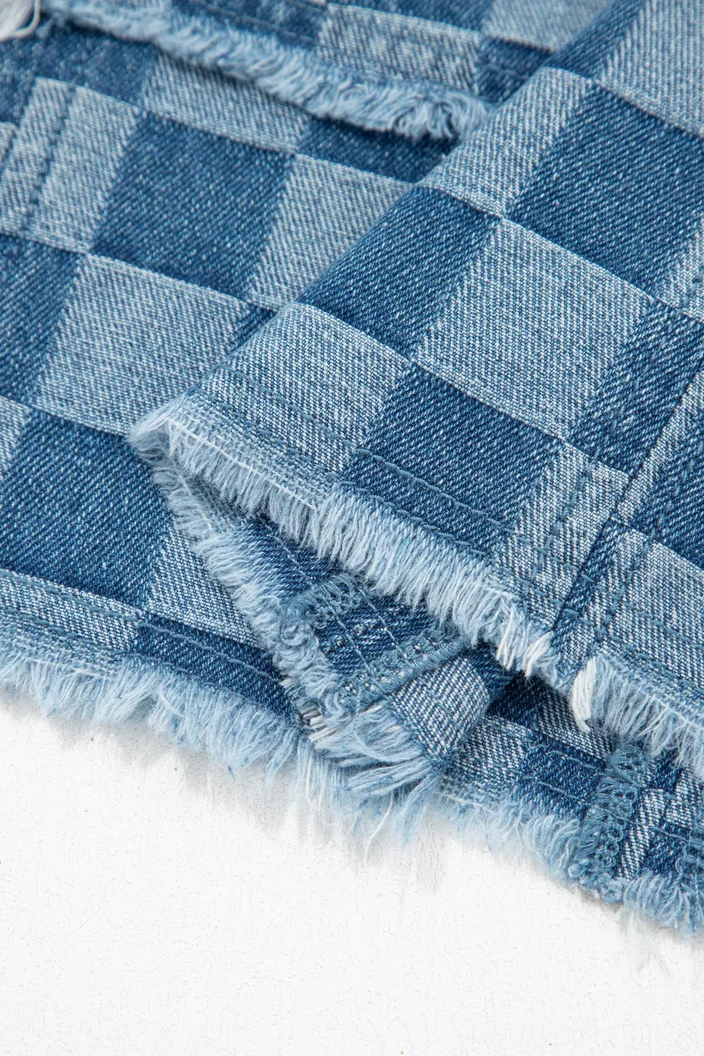Checkered denim mini dress with frayed hems and a casual chic style.