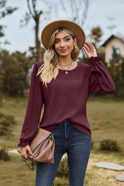 Burgundy waffle knit blouse with perforated yoke and ruffled cuffs
