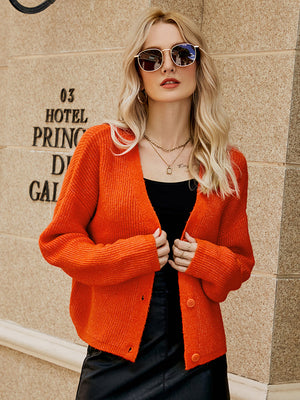 Orange-Red textured button-down knit cardigan with a V-neck and long sleeves.