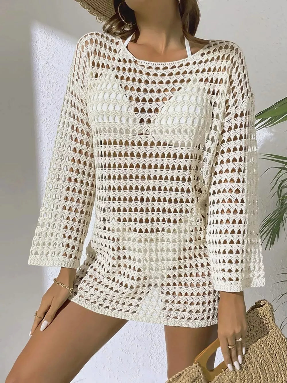 Beige sheer crochet knit cover-up with openwork pattern and long sleeves.