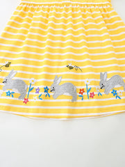 Yellow striped cotton toddler dress with embroidered bunnies and flowers detail.