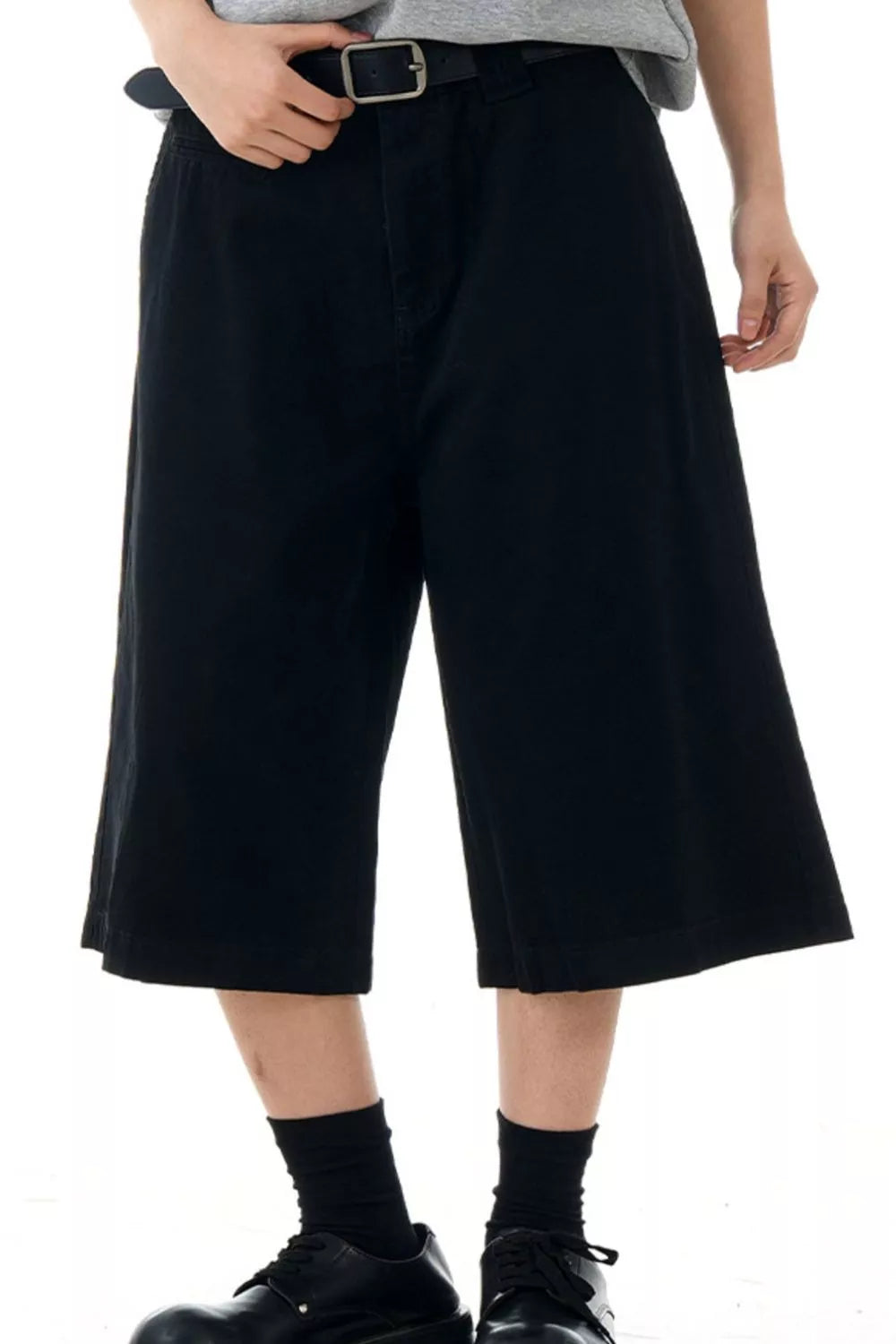 Black relaxed fit bermuda shorts with belt loops and pockets.
