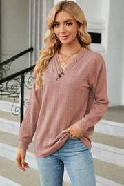 Textured cable-knit henley pullover in Dusty Pink with button detail.