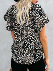 Black leopard print blouse with flutter sleeves and V-neck detail.
