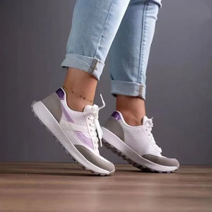 White mesh runners with grey and iridescent purple panels and white laces.