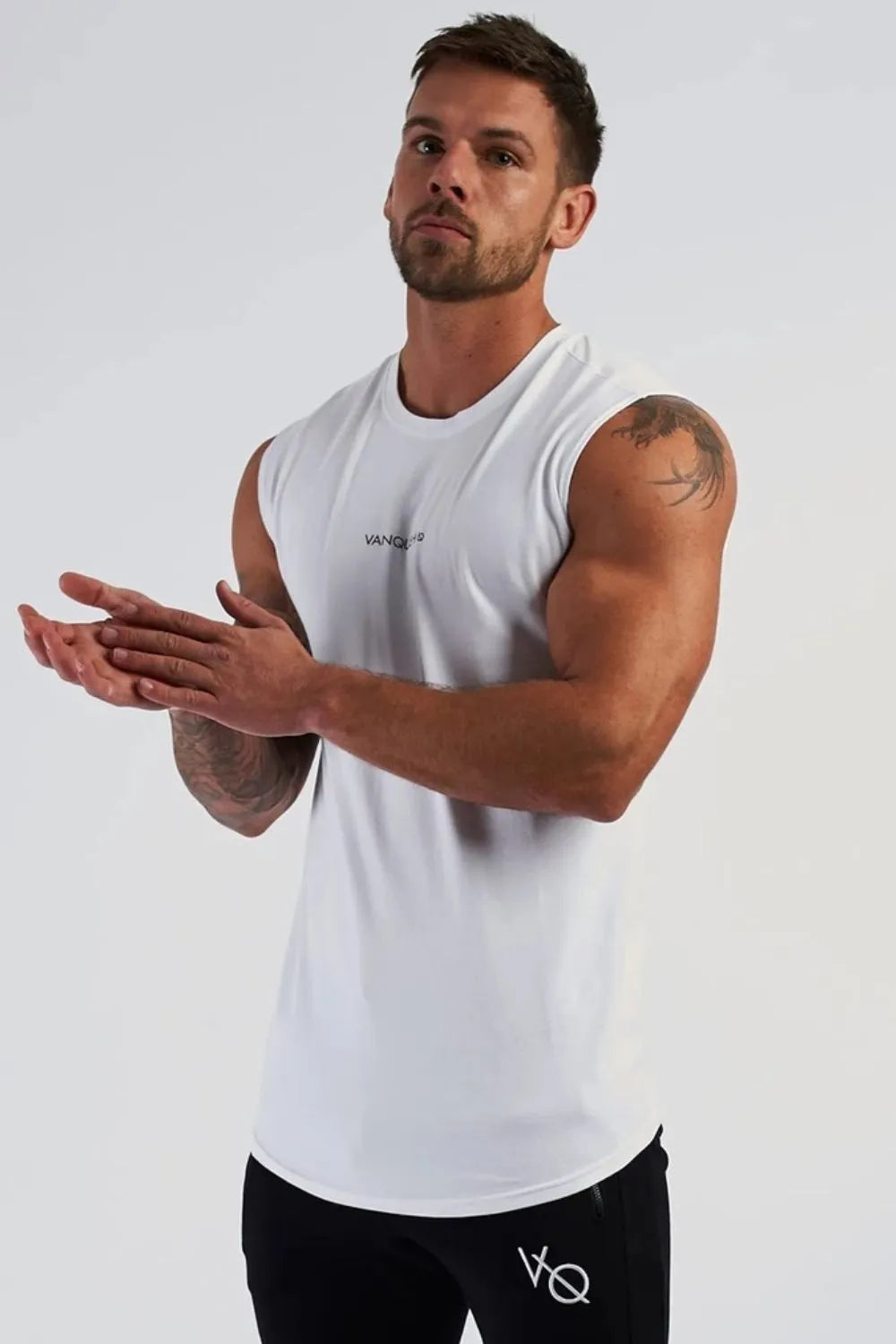 White performance tank top with subtle logo detail on chest and curved hem