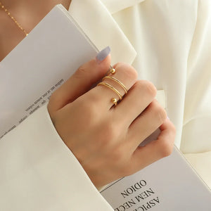 Gold spiral orb ring with double band and beaded ends.