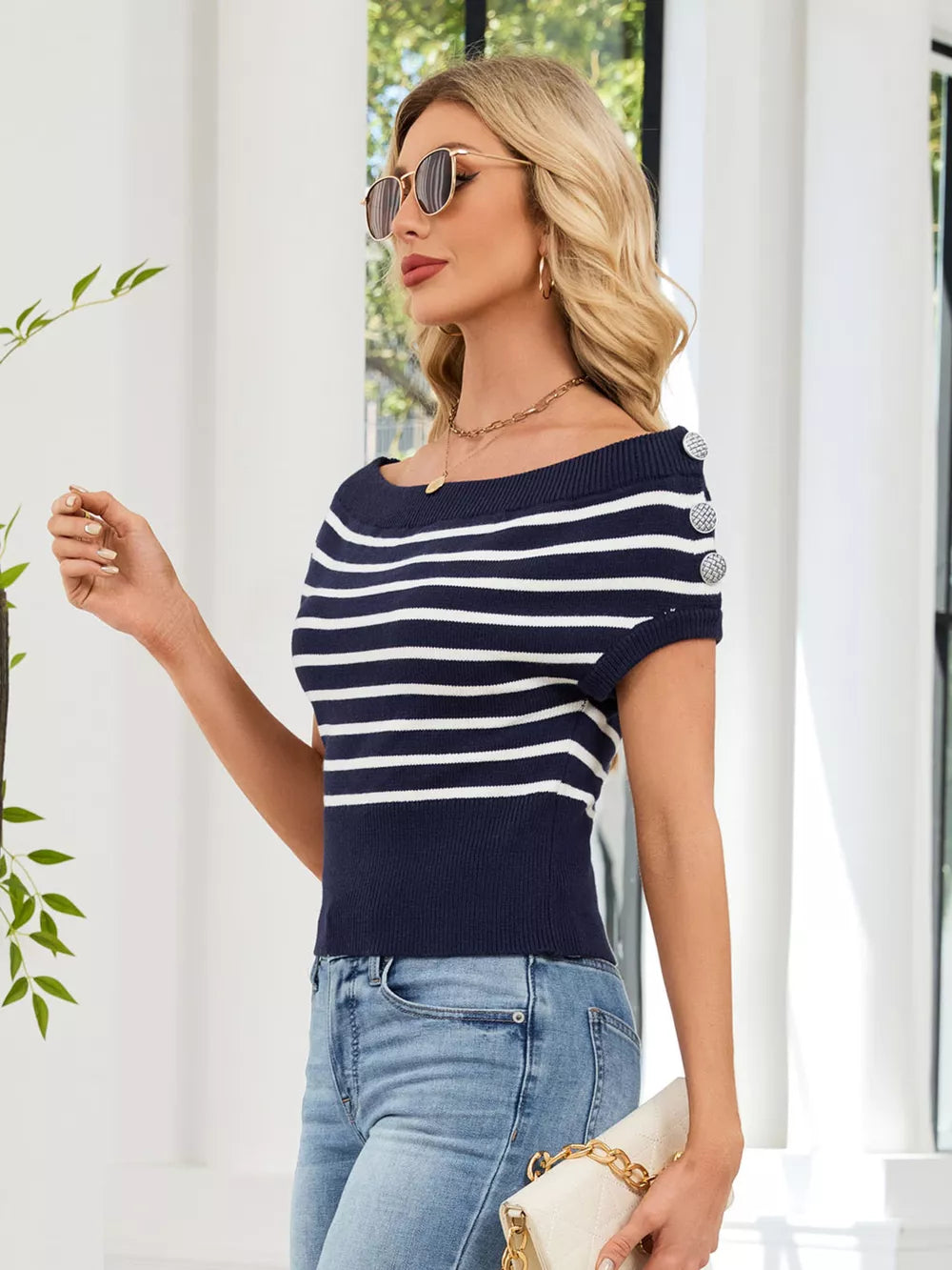 Dark blue and white striped knit sweater with decorative buttons on shoulder