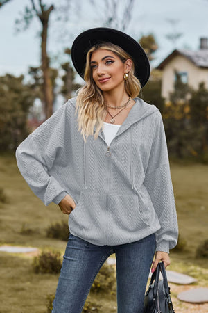 Light Gray textured cable knit zip-up hoodie with pockets and drawstring hood.