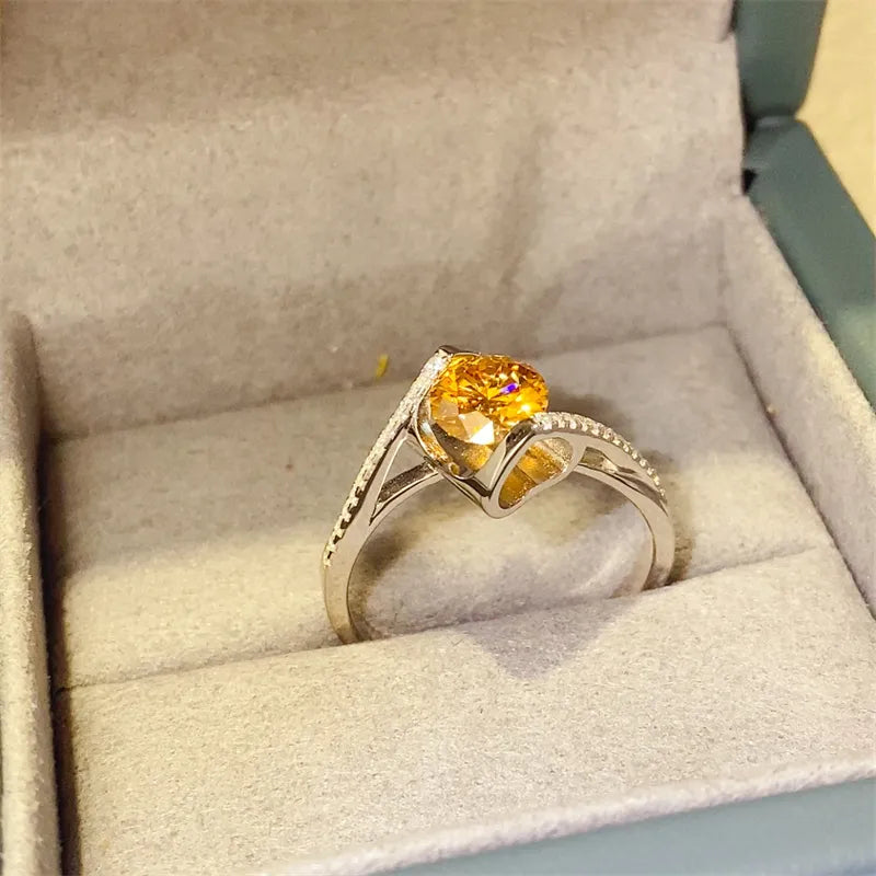 Radiant yellow diamond swirl ring in silver with pave diamond accents.