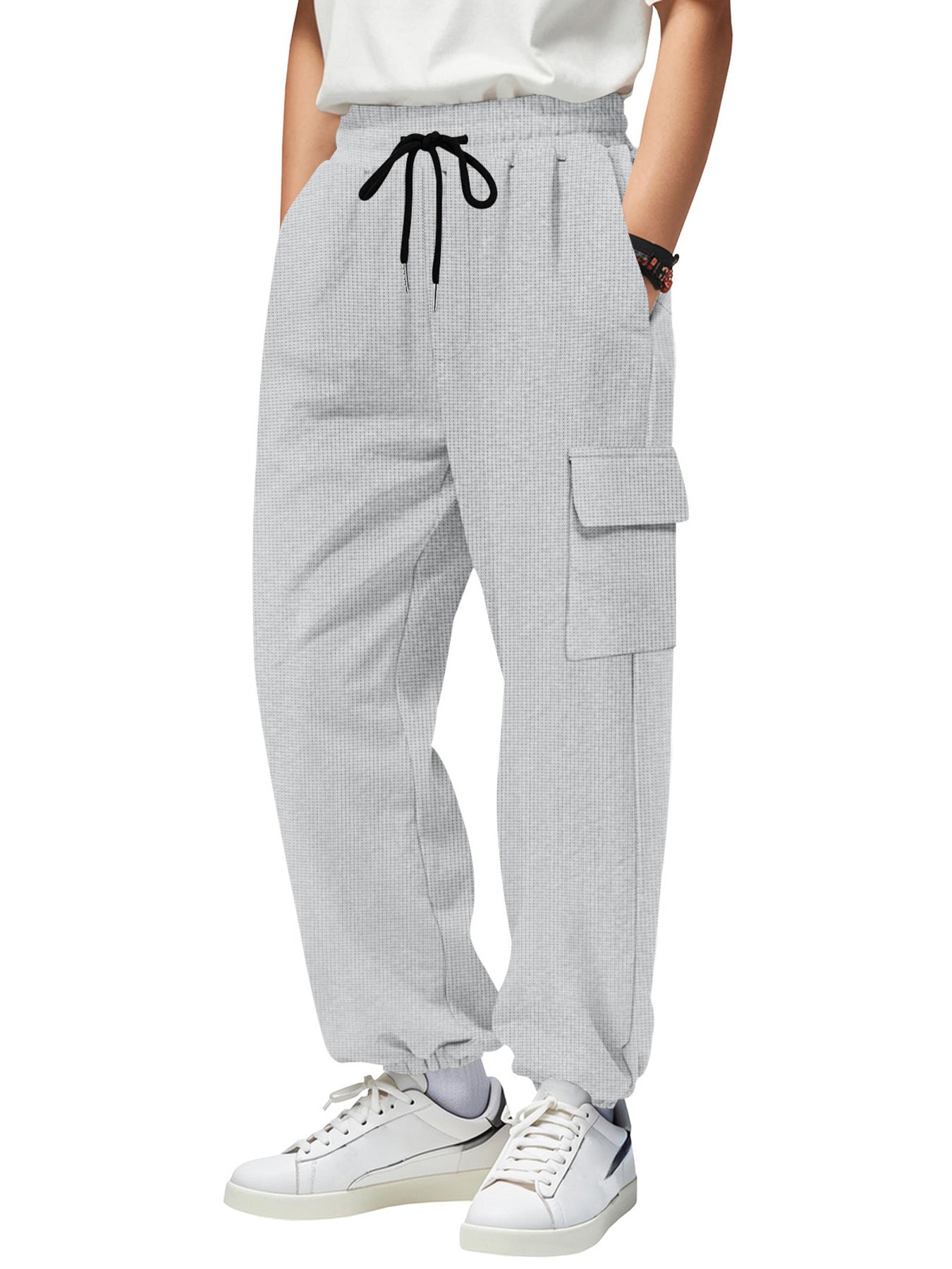 Light gray waffle knit joggers with drawstring and cargo pocket detail.