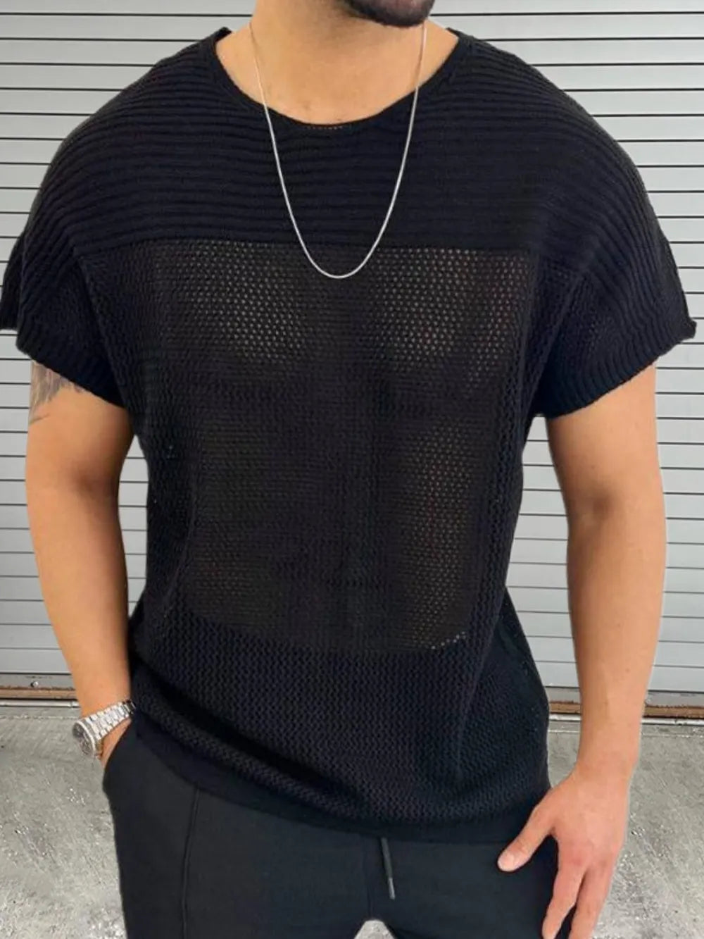 Black open knit boxy t-shirt with crew neck and short sleeves, made of acrylic.
