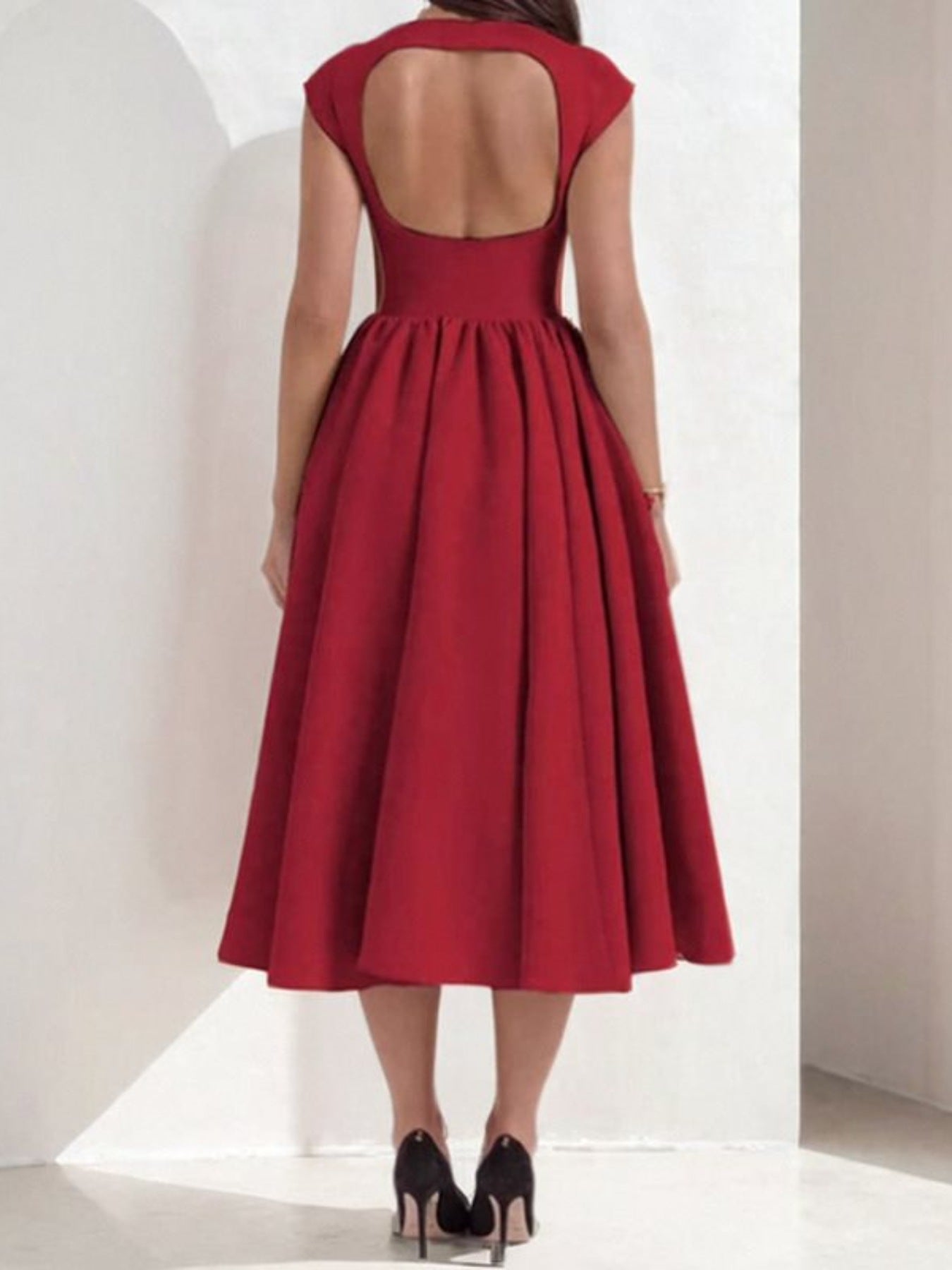 Deep red A-line midi dress with cap sleeves and a cutout back.