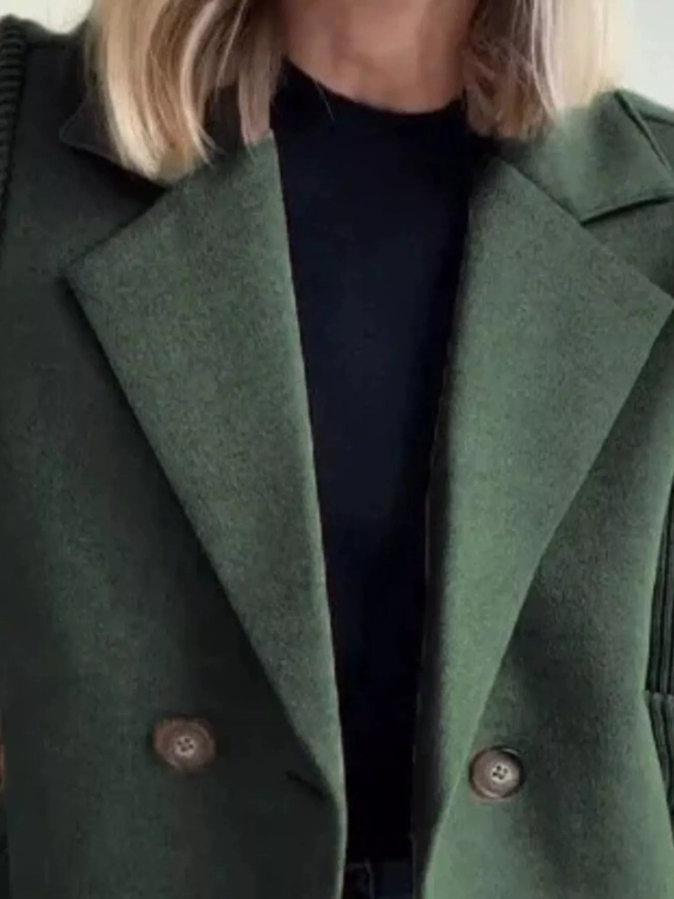 Green double-breasted wool blend blazer with button detail and notched lapels.
