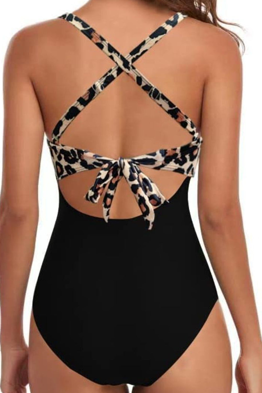 Black one-piece swimsuit with leopard print crisscross halter straps and back tie detail