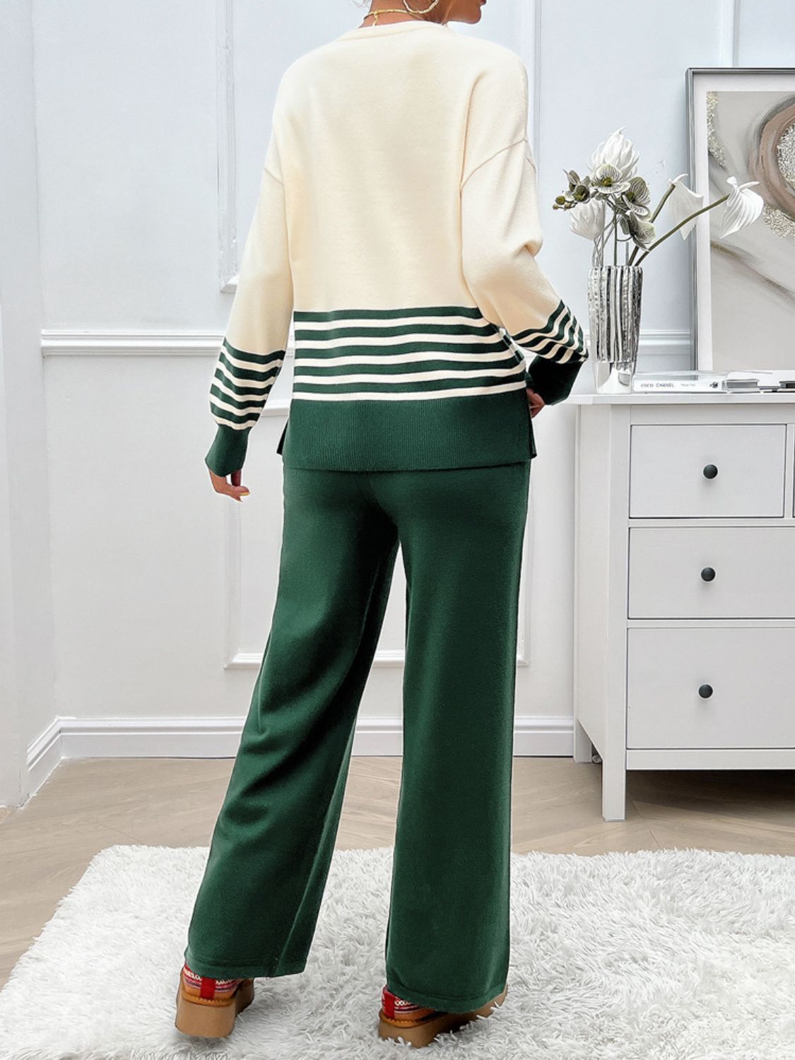 Color-blocked knit lounge set in cream and dark green with horizontal stripes on sleeves and hem.