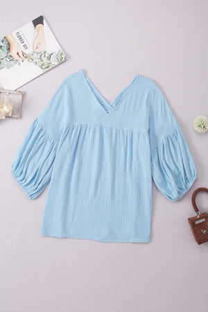 Pastel blue textured gauze blouse with gathered sleeves and V-neck