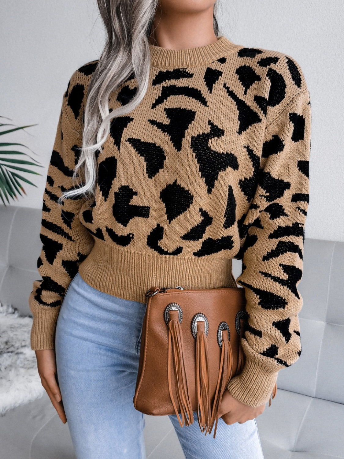 Camel abstract knit cropped sweater with black pattern, crew neck, and ribbed cuffs.