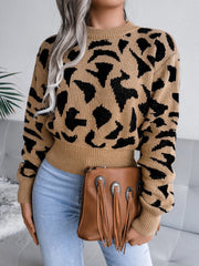 Camel abstract knit cropped sweater with black pattern, crew neck, and ribbed cuffs.