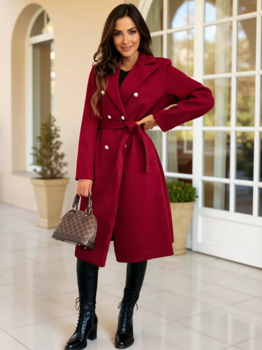 Red tailored double-breasted trench coat with waist tie and pearl buttons